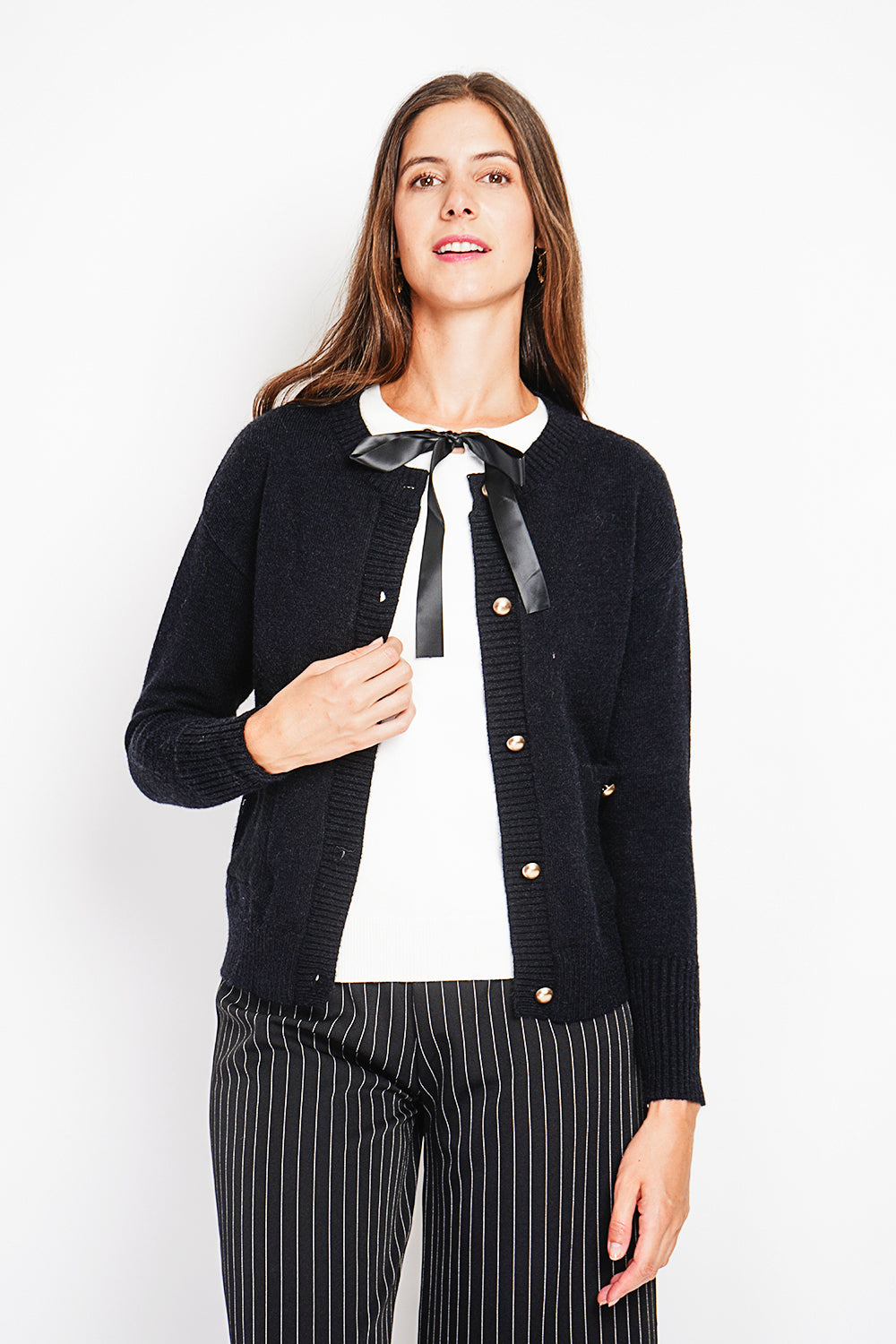 Crew neck vest with fancy buttoned front pockets and long sleeves