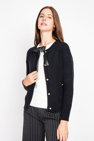 Crew neck vest with fancy buttoned front pockets and long sleeves