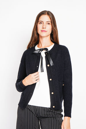 Crew neck vest with fancy buttoned front pockets and long sleeves
