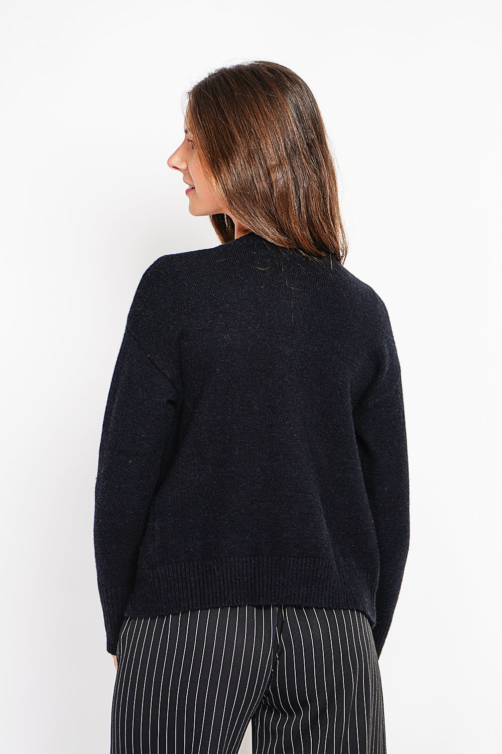 Crew neck vest with fancy buttoned front pockets and long sleeves