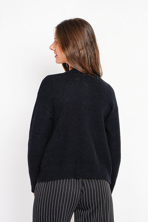 Crew neck vest with fancy buttoned front pockets and long sleeves