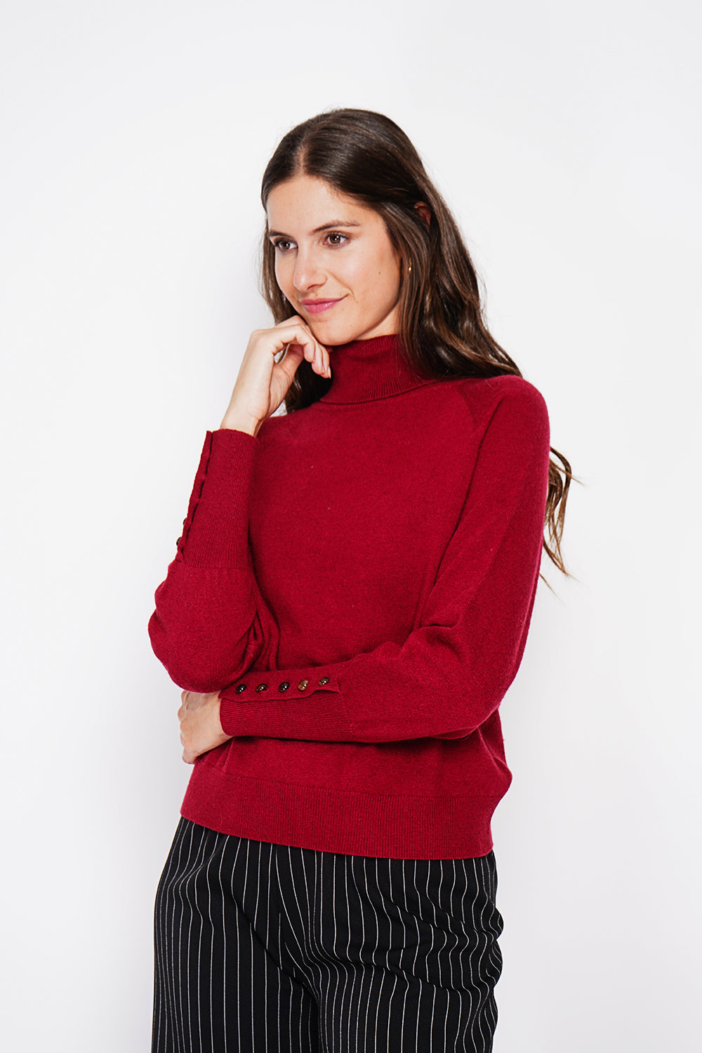 Oversized turtleneck sweater with button placket at the bottom of the long sleeves