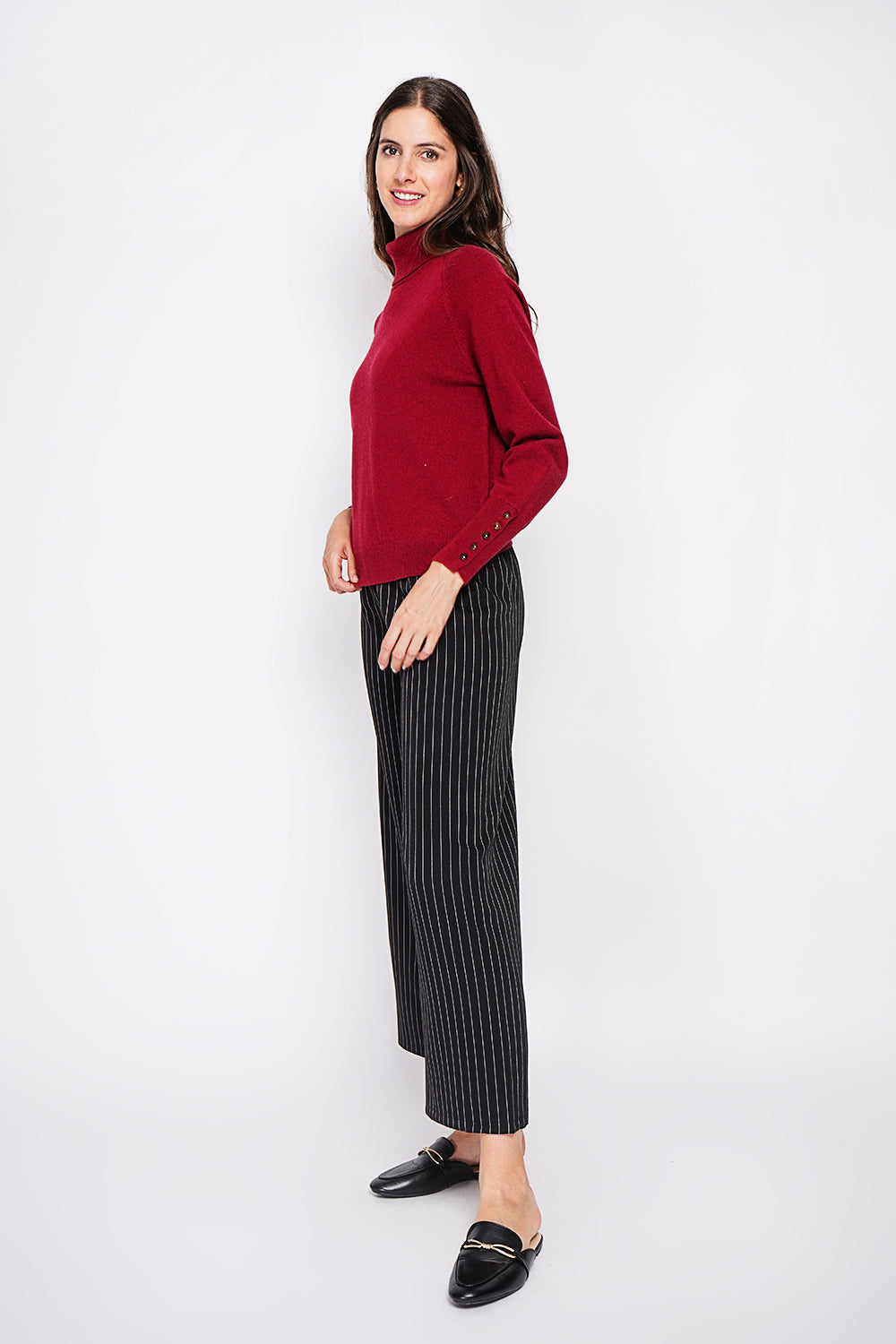 Oversized turtleneck sweater with button placket at the bottom of the long sleeves