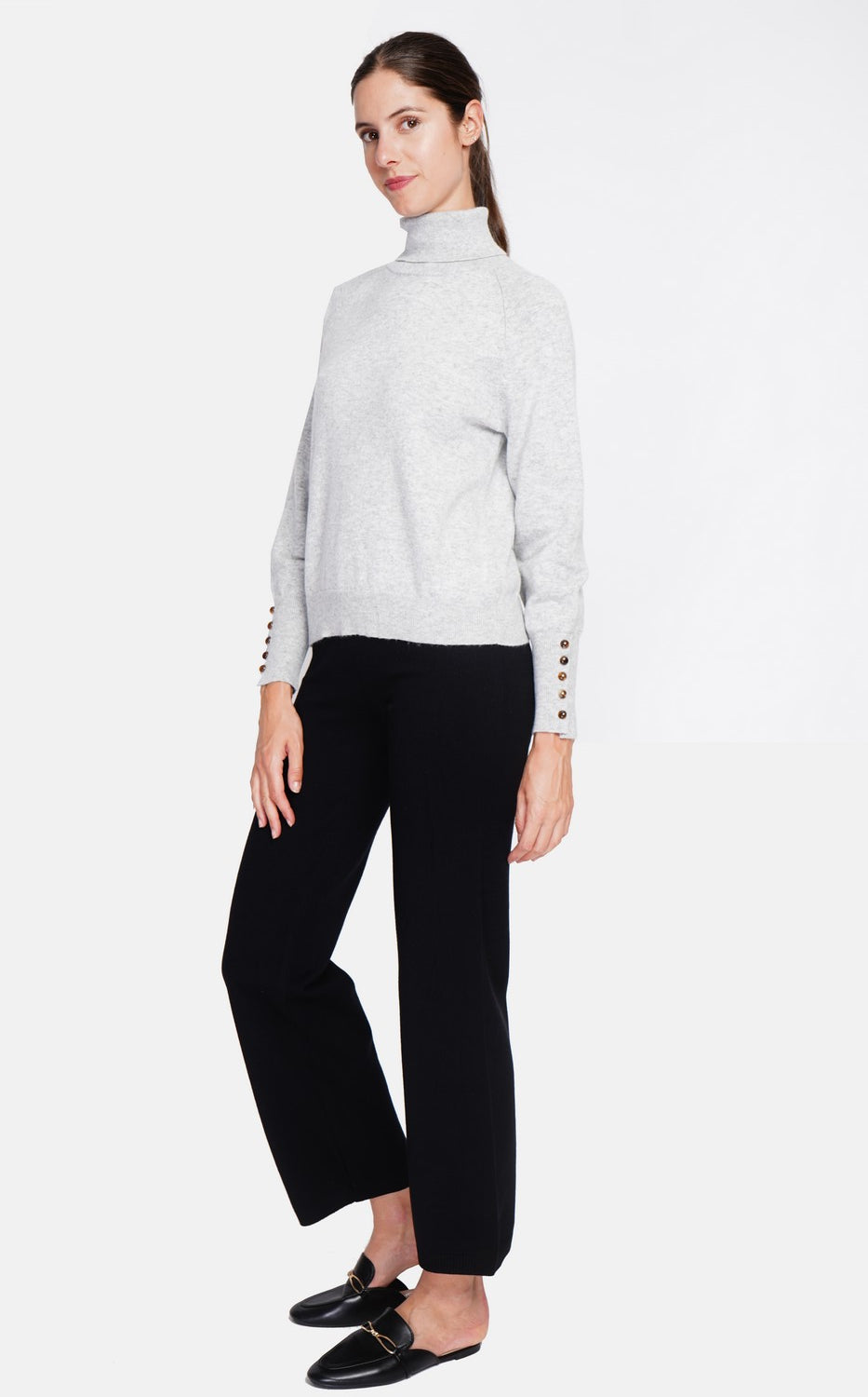 Oversized turtleneck sweater with button placket at the bottom of the long sleeves