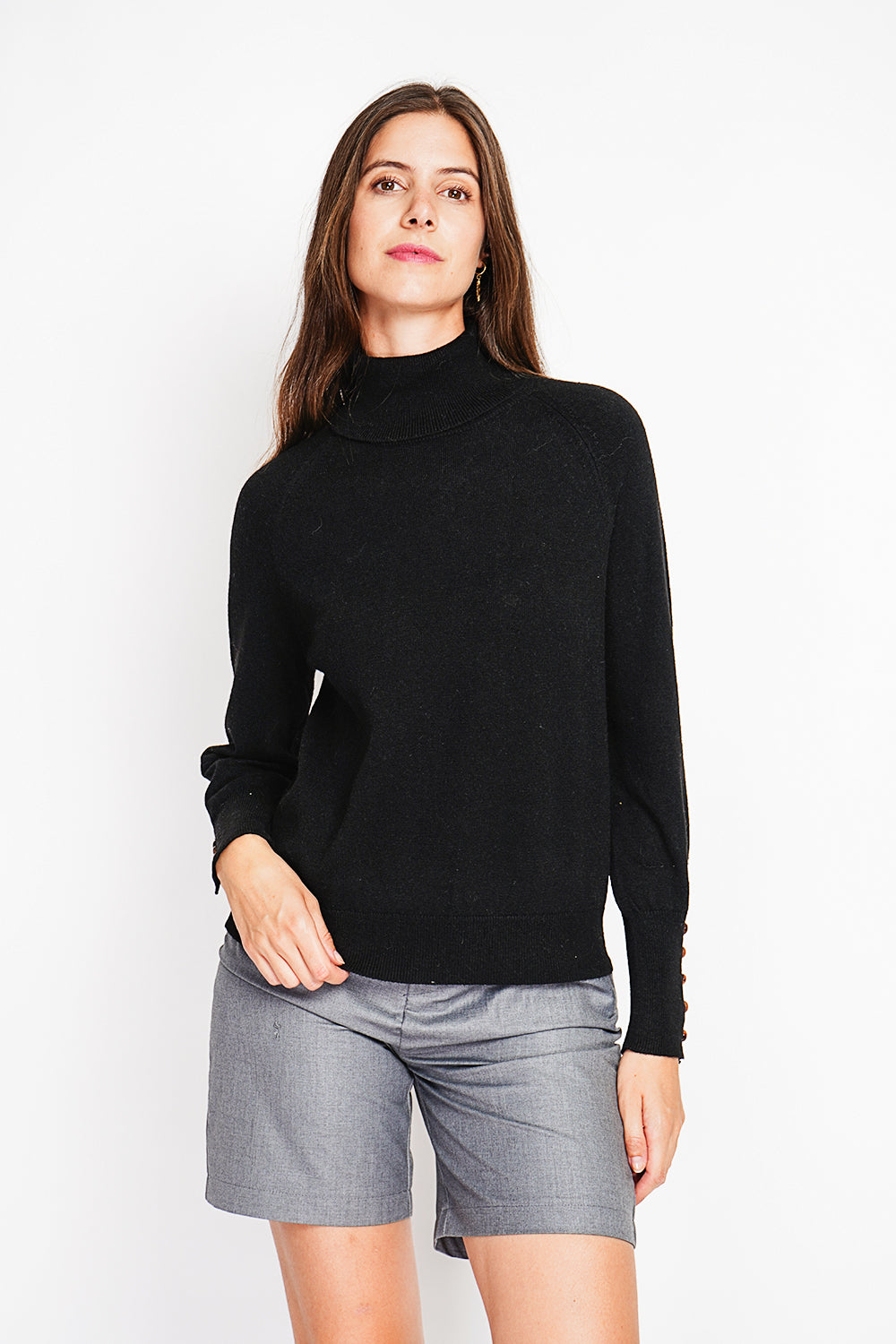 Oversized turtleneck sweater with button placket at the bottom of the long sleeves