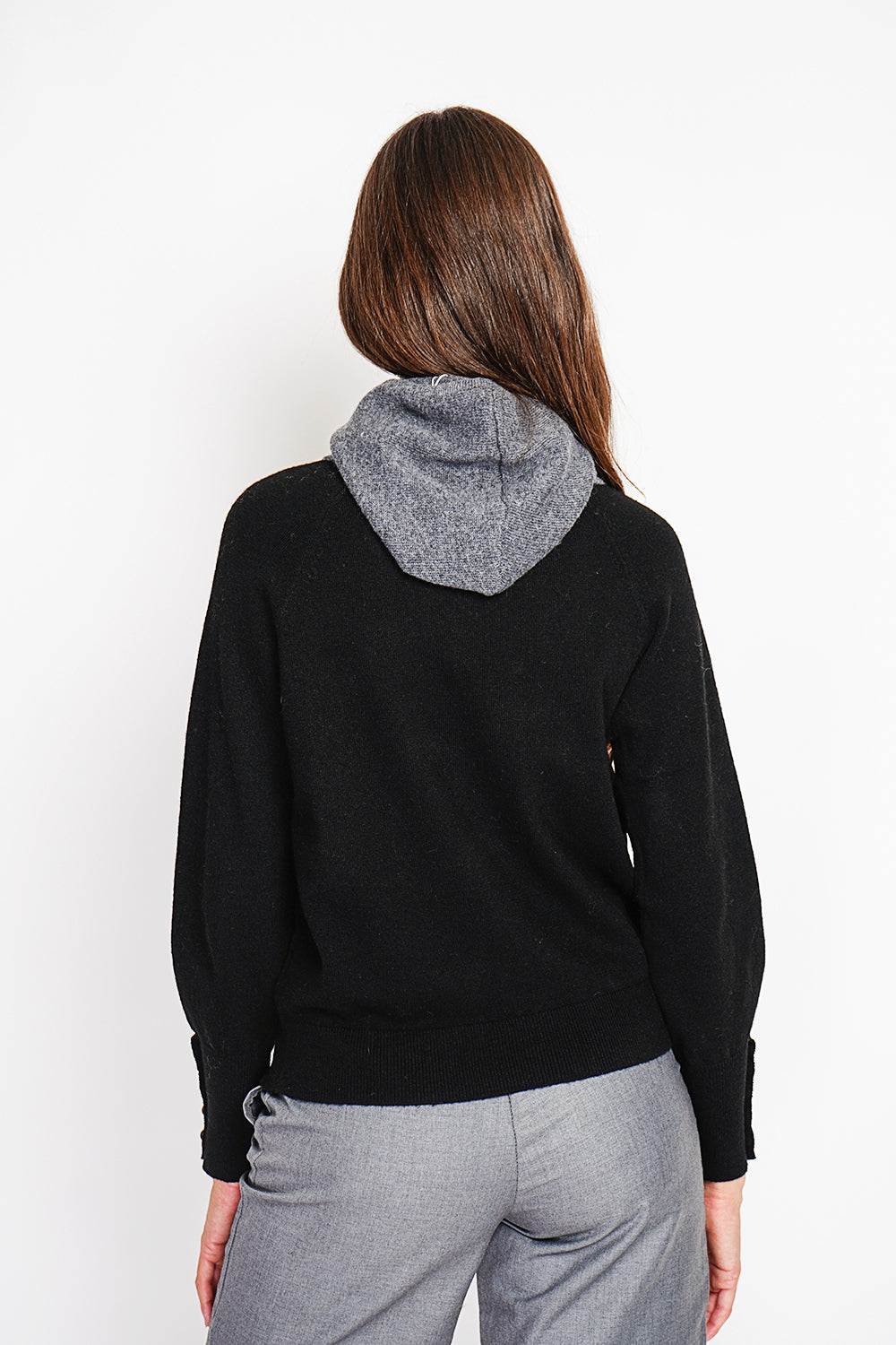 Oversized turtleneck sweater with button placket at the bottom of the long sleeves