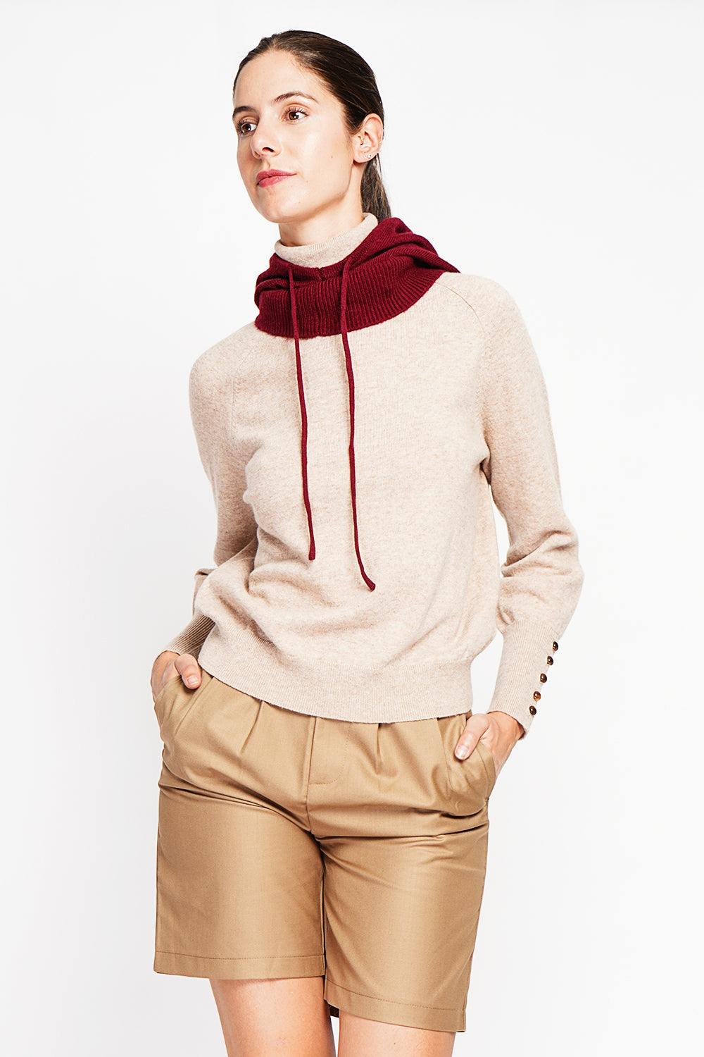 Oversized turtleneck sweater with button placket at the bottom of the long sleeves