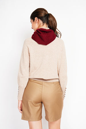 Oversized turtleneck sweater with button placket at the bottom of the long sleeves
