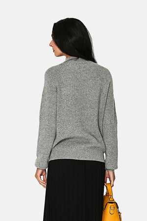 Slightly high neck sweater, cable knit at the collar, armholes, cuffs