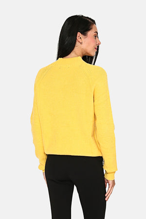 Slightly high neck sweater, cable knit at the collar, armholes, cuffs